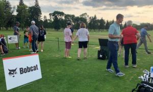 Bigs and Littles take part in a golf clinic at the Fargo Country Club