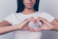 Girl making heart shape with her hands